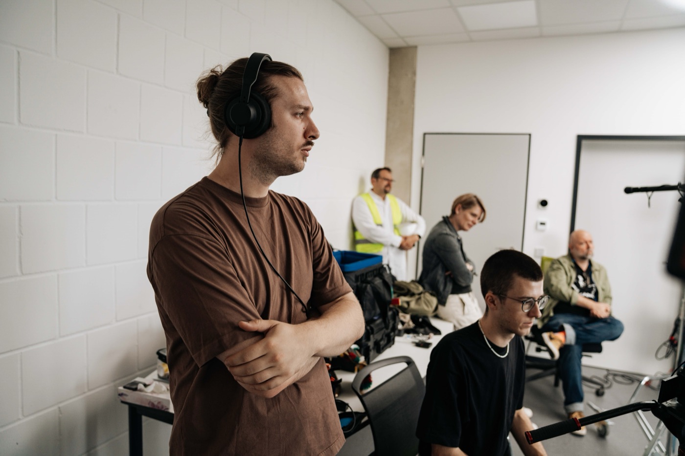 Gleb Lasarew mit Kopfhörern beim Monitoring, konzentriert neben der Crew.
